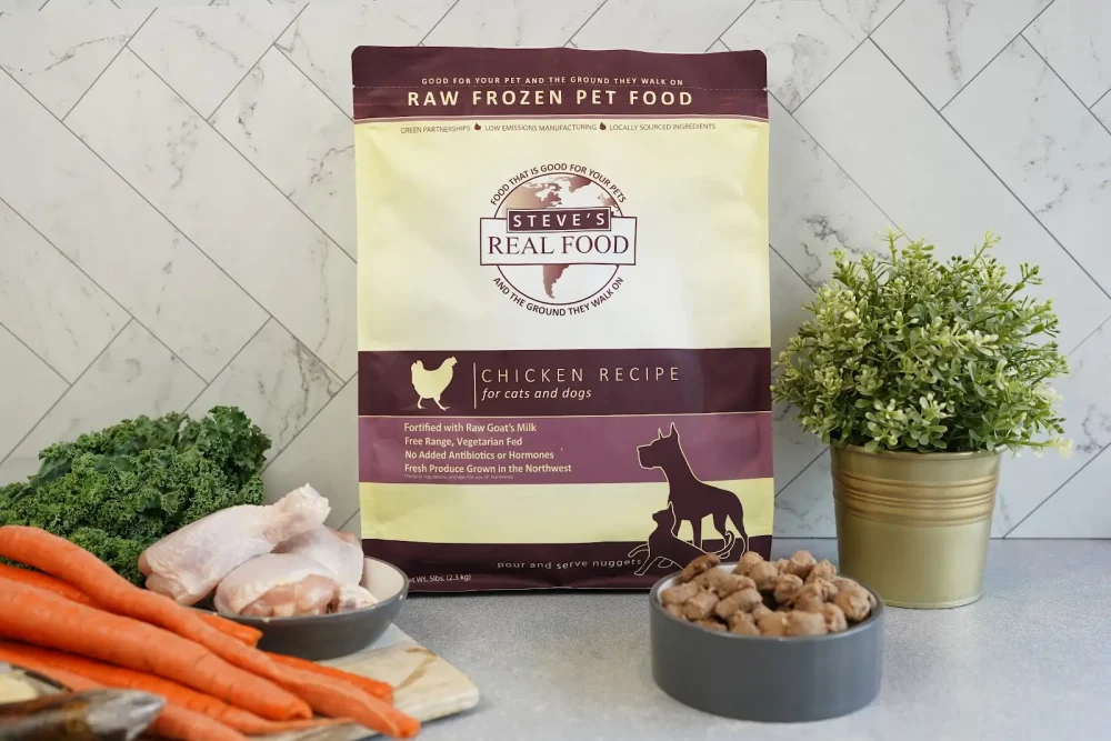 Front of bag of Raw Frozen Pet Food Chicken Recipe surrounded by meat and vegetables