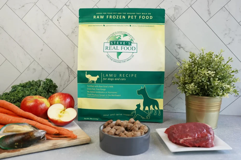 Front of bag of Raw Frozen Pet Food Lamu Recipe surrounded by meat and vegetables