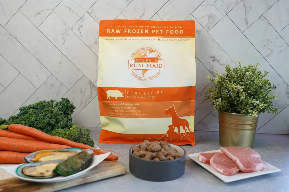Front of bag of Raw Frozen Pet Food Pork Recipe surrounded by meat and vegetables