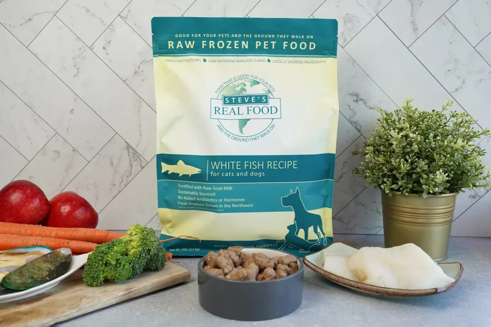 Front of bag of Raw Frozen Pet Food White Fish Recipe surrounded by meat and vegatables